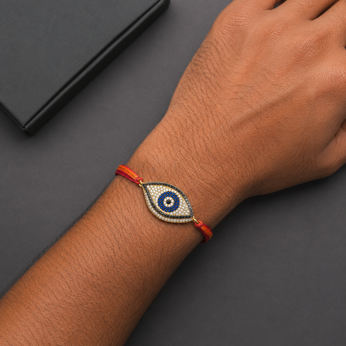 Designer Oval Evil Eye Black CZ Red Orange Thread Rakhi For Men
