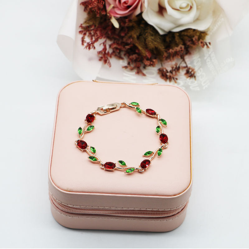 Elegant Rose Gold Bracelet With Red Crystals And Green Leaves